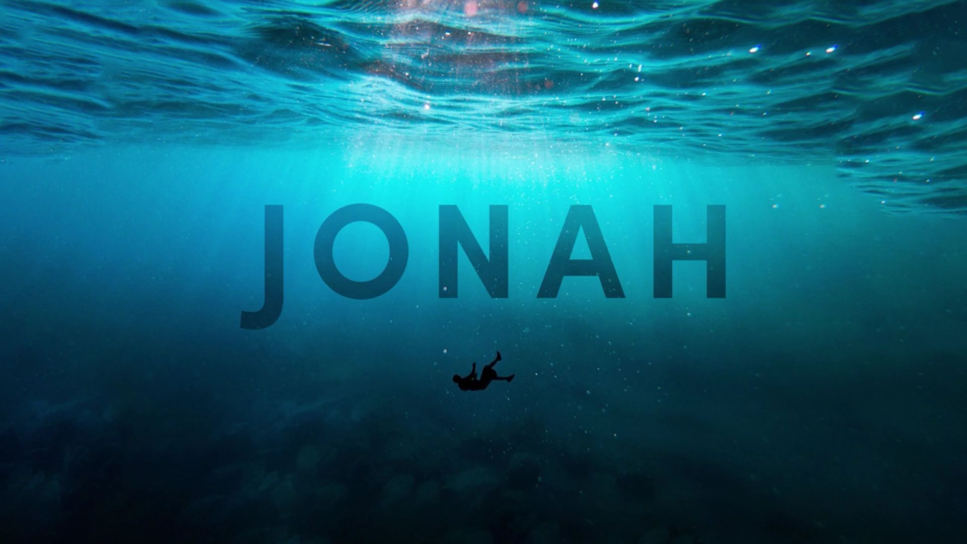 A figure sinks into deep blue water beneath the title 