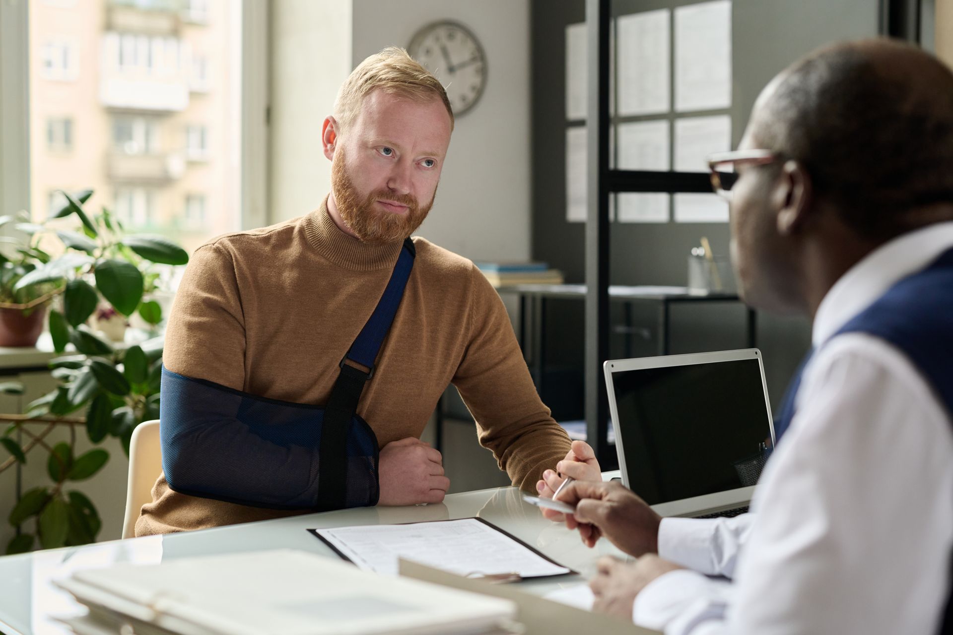 An accident attorney consulting an injured client.