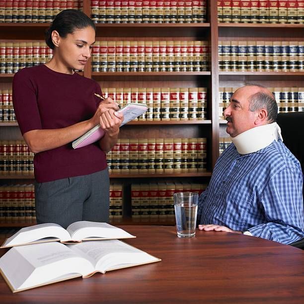A lawyer is writing down some information from her injured client.