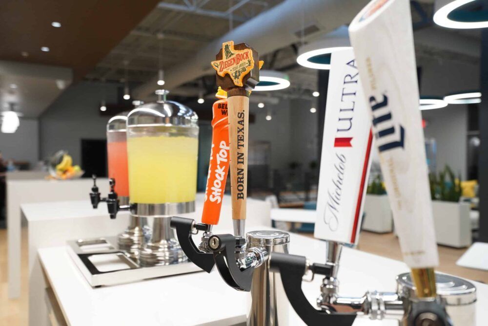 Beer taps with branded handles at a bar counter, including a white Ultra tap in the foreground