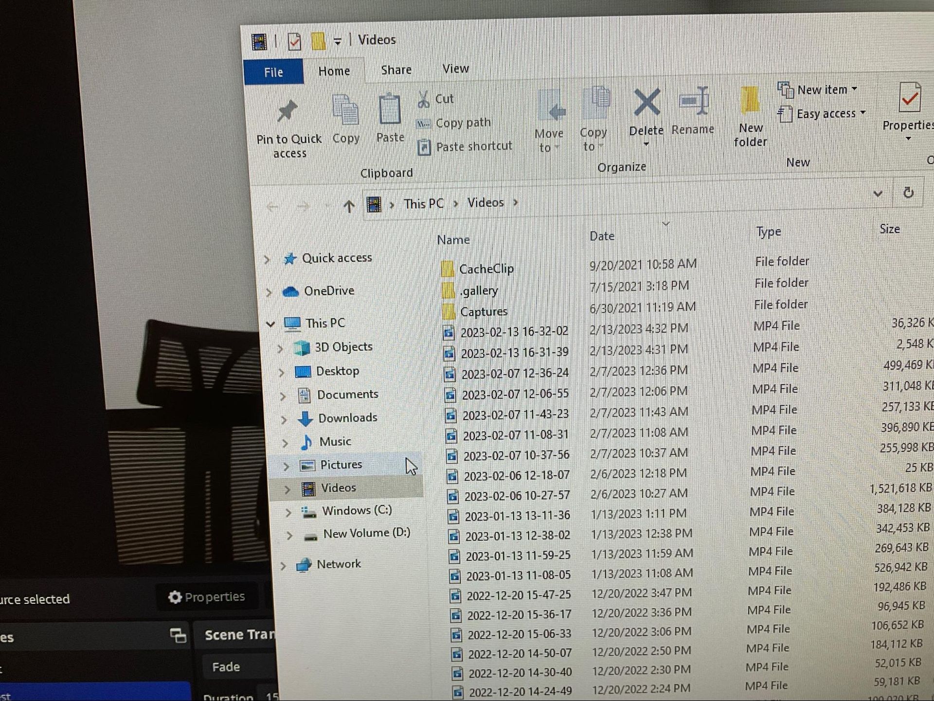 Blurry photo of a laptop screen showing Windows File Explorer with a folder list and file details.