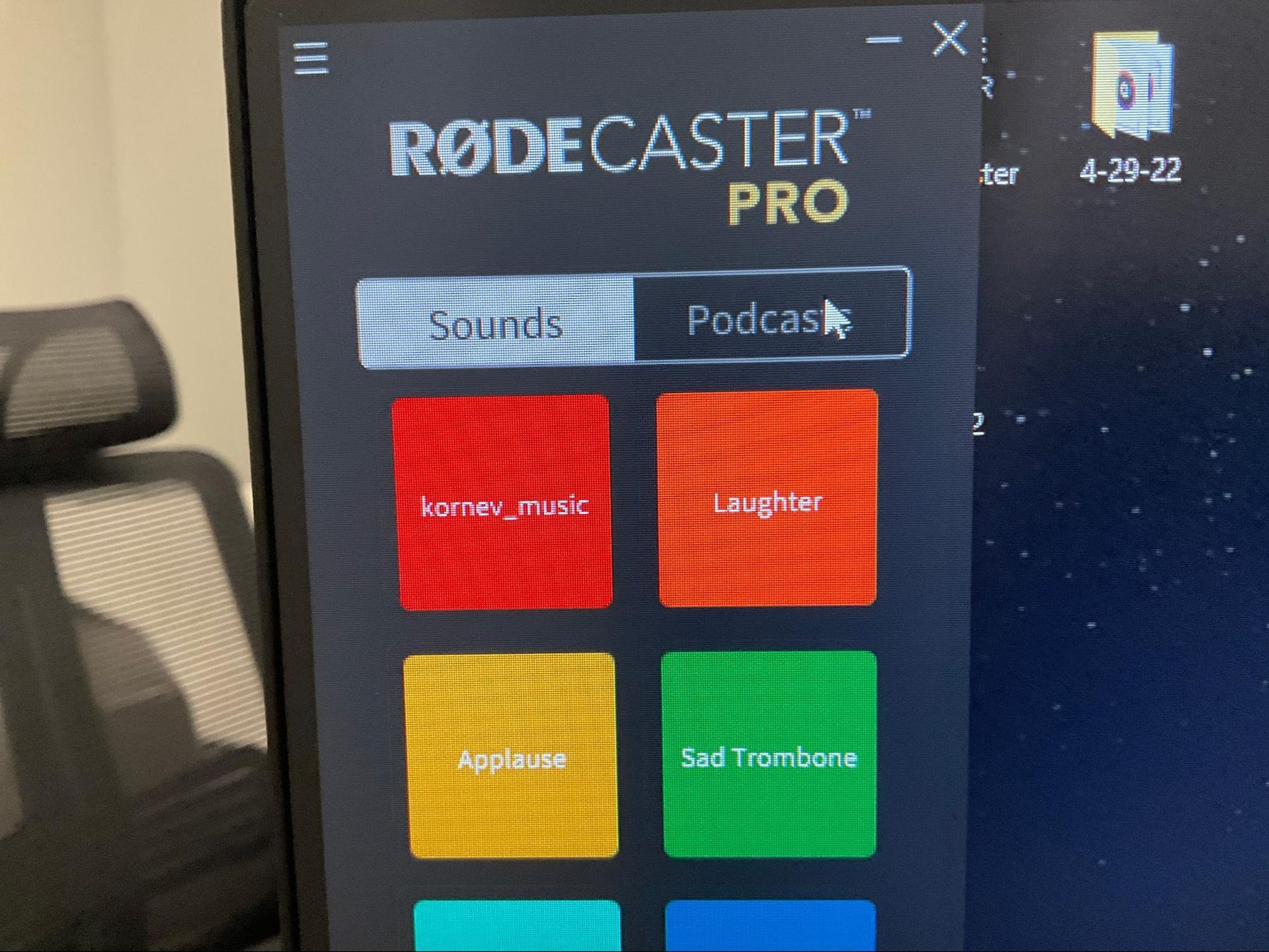 Close-up of RØDECaster Pro touchscreen showing colorful podcast sound pads on a desk
