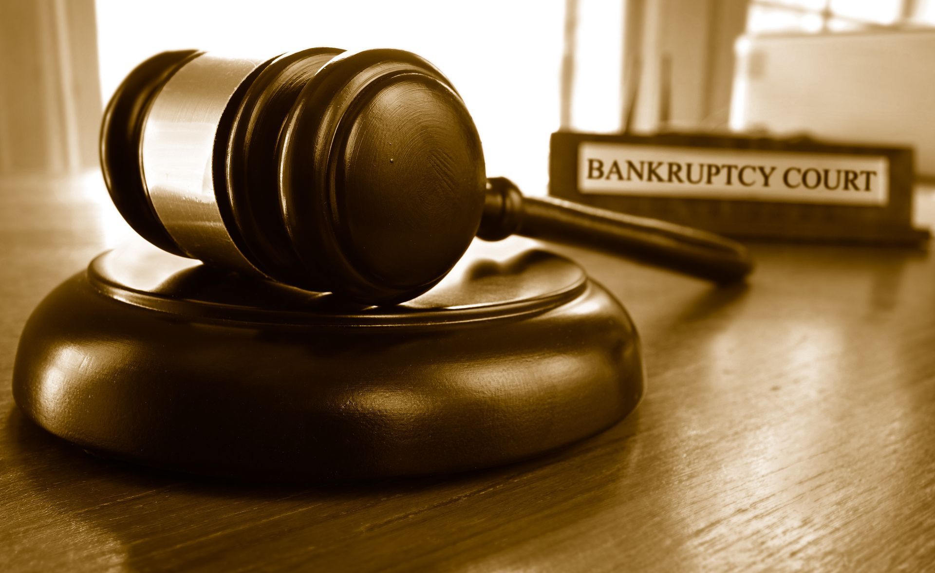 Gavel rests near a jar of coins symbolizing legal financial issues. Gavel rests near a jar of coins symbolizing legal financial issues.