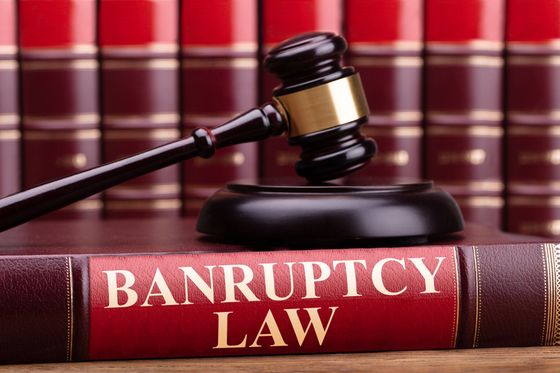 A gavel rests on a bankruptcy law book, symbolizing judicial authority in financial cases. A gavel rests on a bankruptcy law book, symbolizing judicial authority in financial cases.