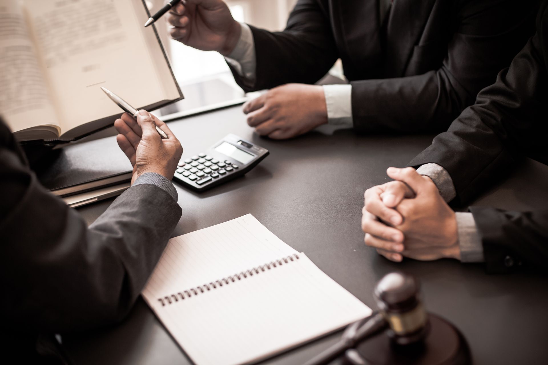 Group of business people and lawyers discussing contract papers. Group of business people and lawyers discussing contract papers.