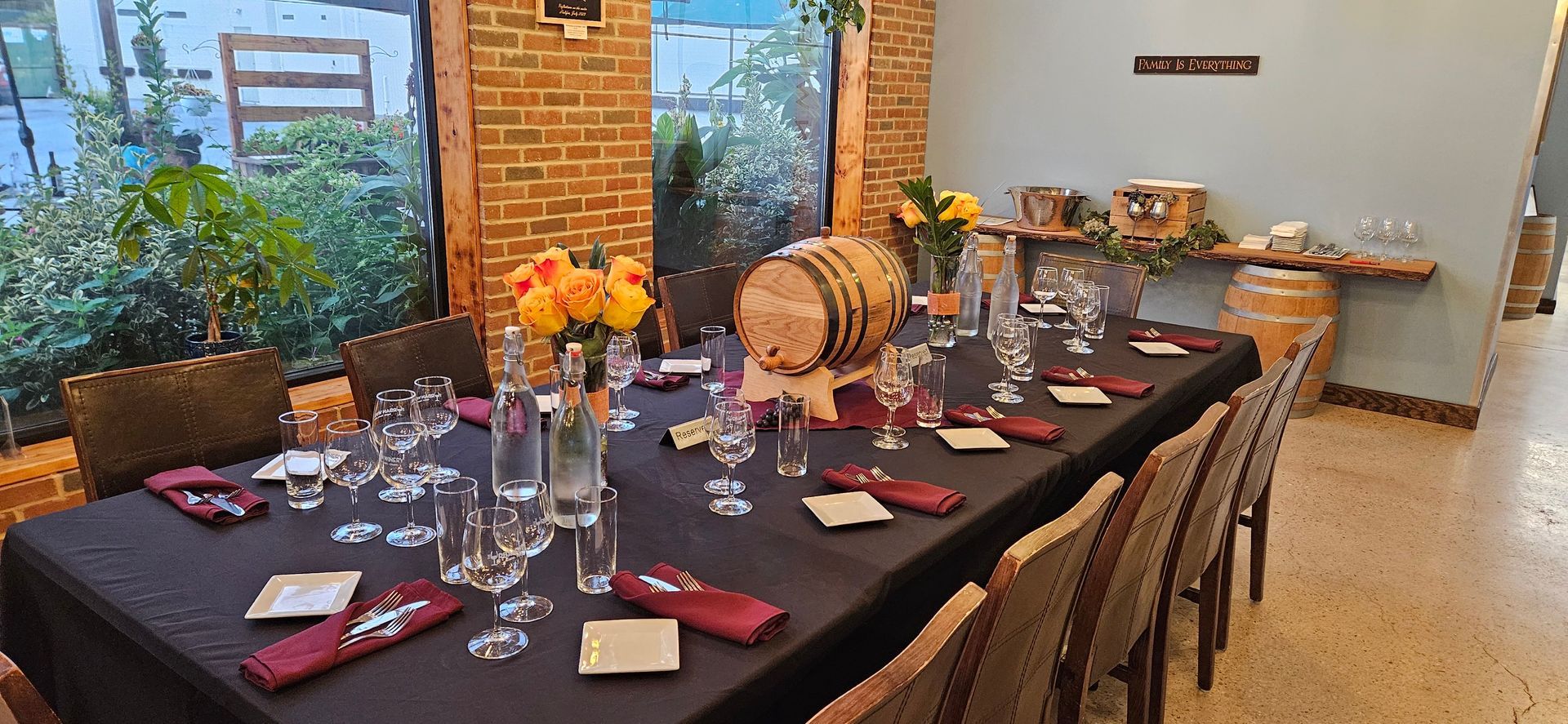 Set dining table with candles, wine glasses, flowers, and autumn decor in a rustic indoor room