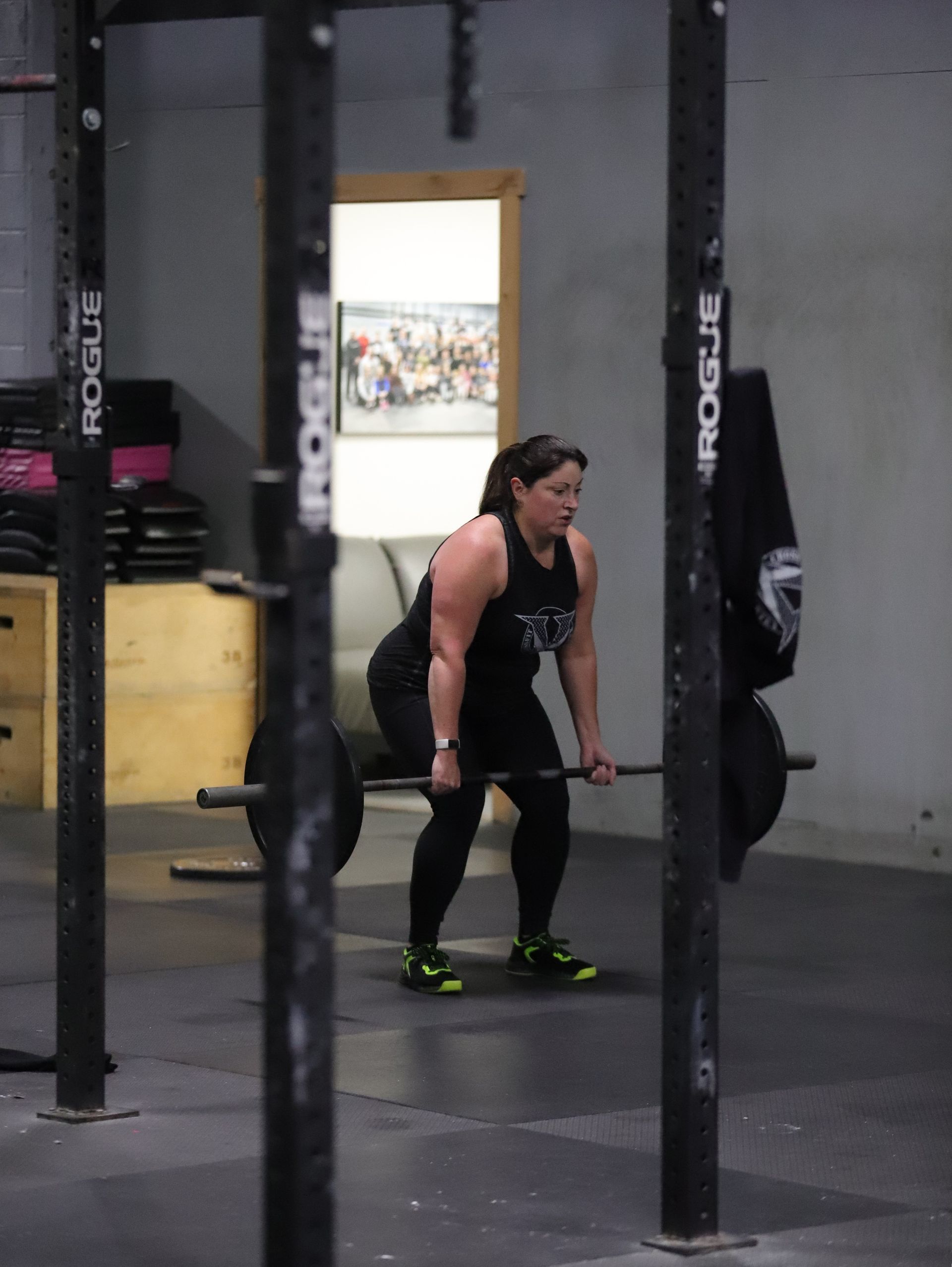 A woman performs a deadlift.