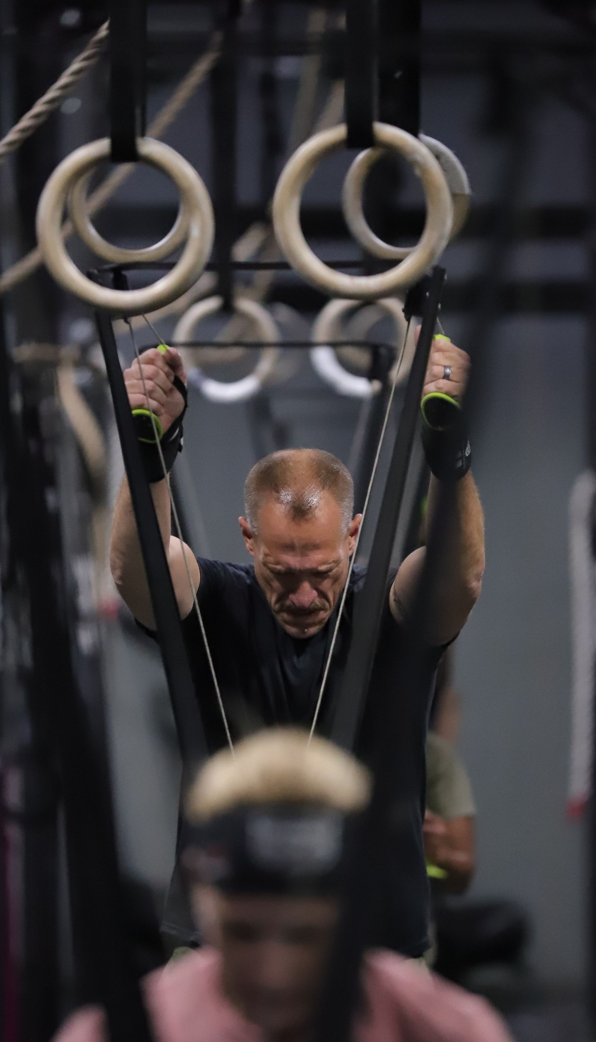 A man using a cardio skiing machine. A man using a cardio skiing machine.