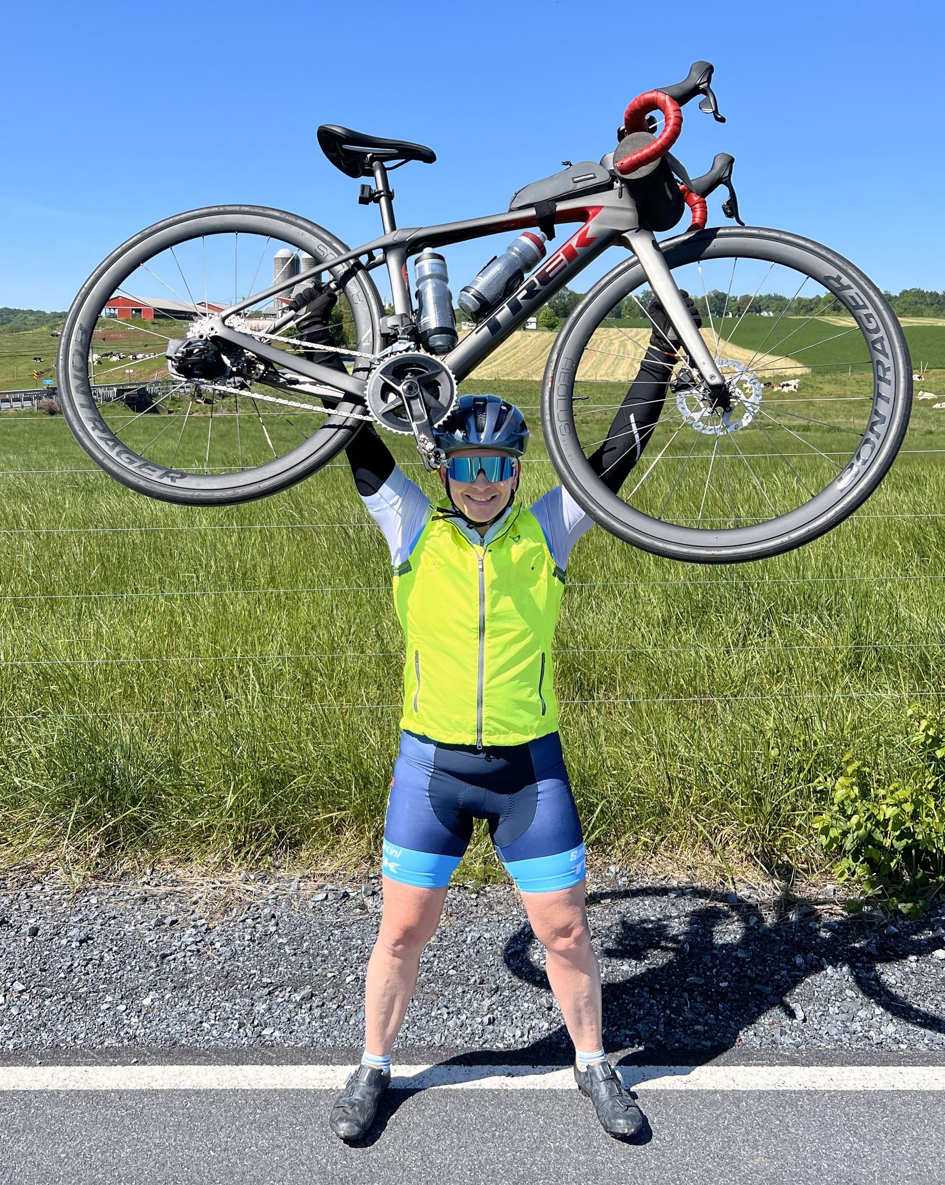 Coach Deb hoists her bike in the air!