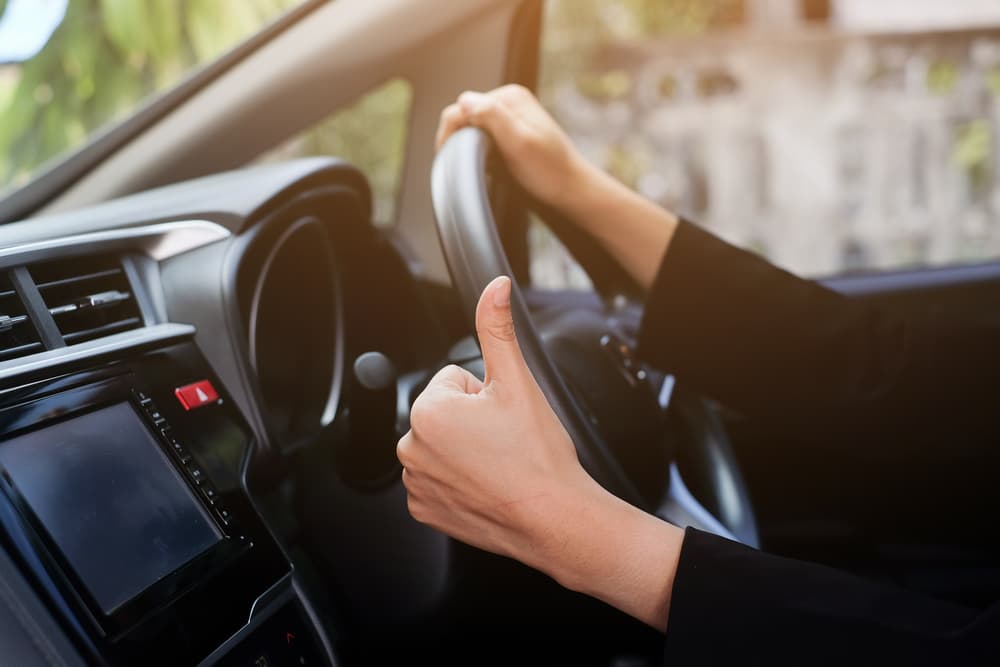 Woman Putting Thumbs Up While Driving — NT Driving Academy in Woolner, NT