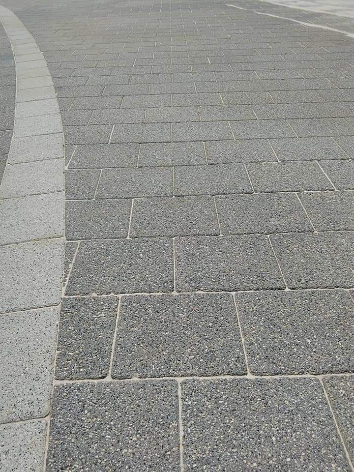 Gray brick paving with a lighter gray border.
