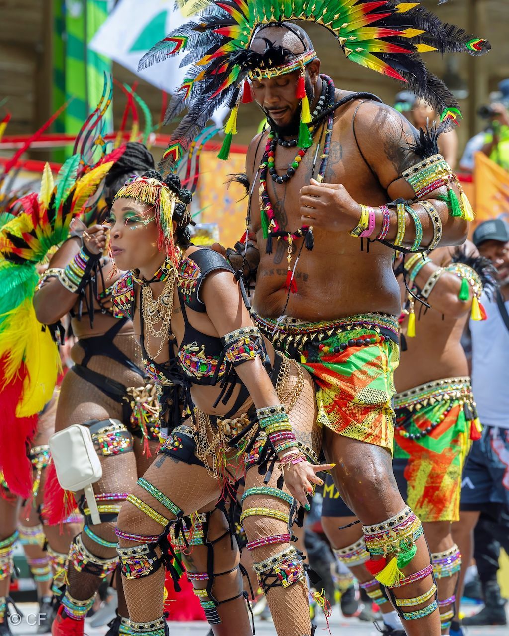 a group of people in colorful costumes are dancing in a parade .