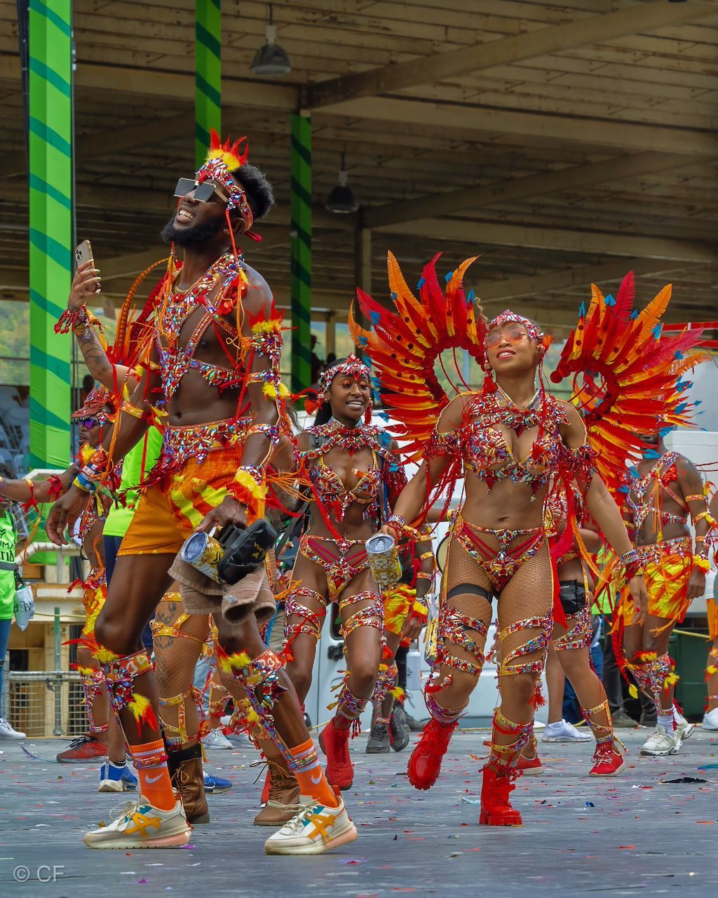 a woman in a colorful costume is walking down the street
