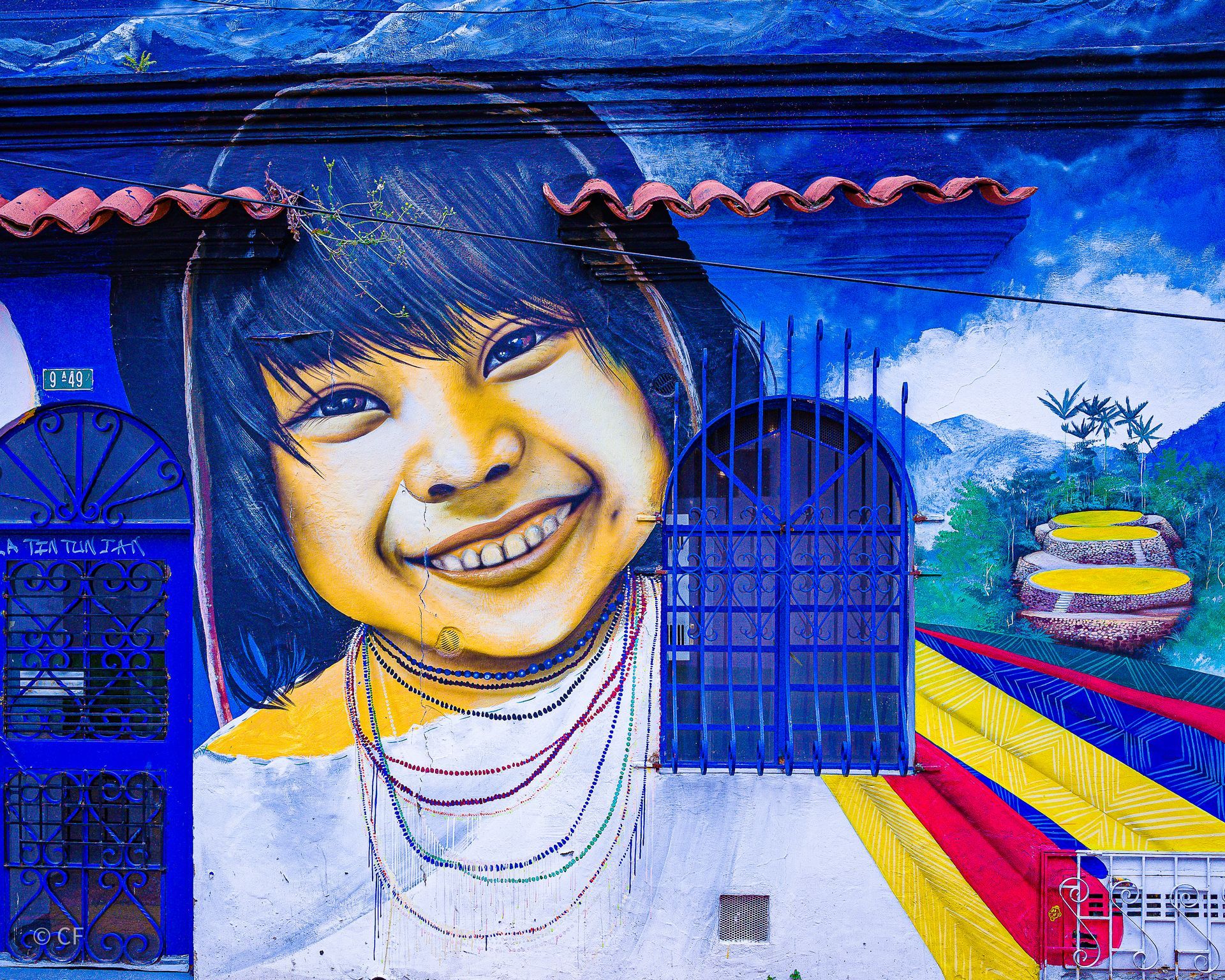 A painting of a girl smiling on a wall