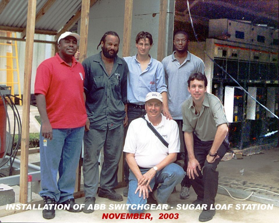 Five workers posing at ABB switchgear installation site, with “November, 2003” caption at bottom