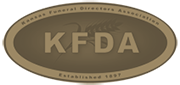 Logo for Kansas Funeral Directors Association: an oval bronze-colored seal with the letters 