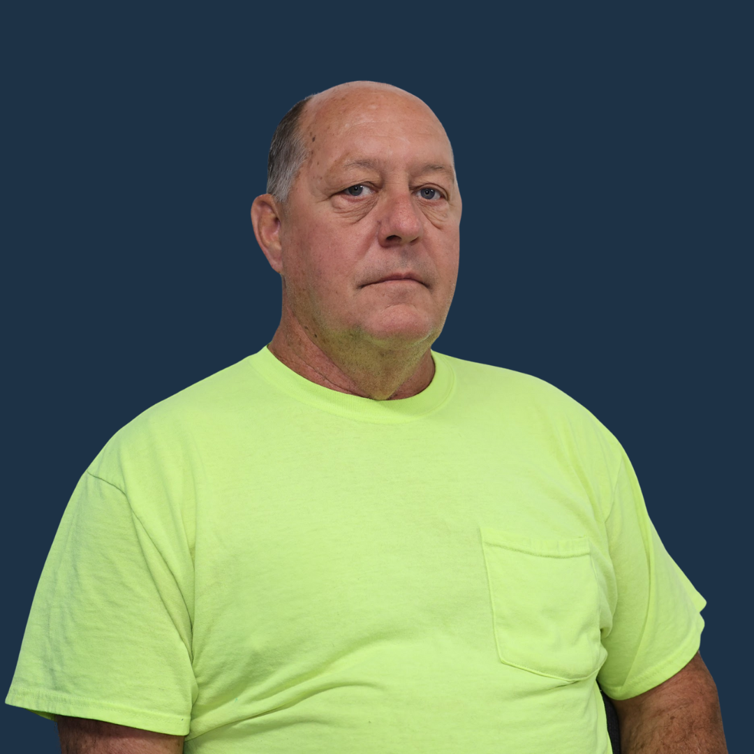 Man in a neon yellow shirt against a dark blue background