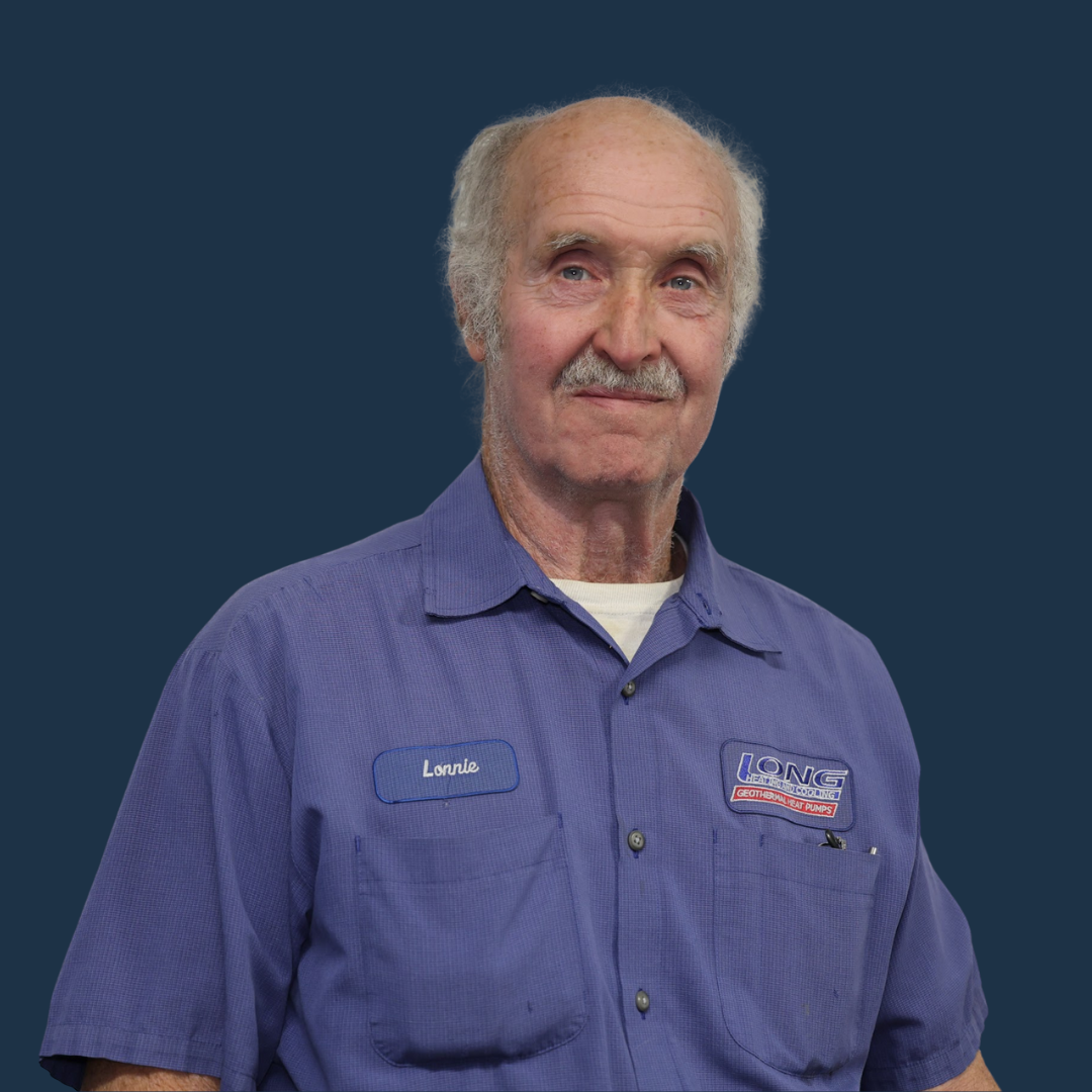 Man in a blue work shirt smiling against a plain blue background