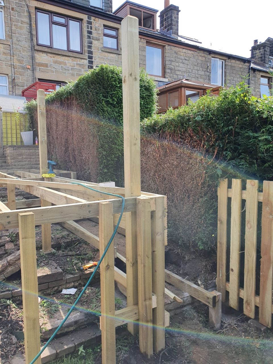 Timber frame for a raised deck being built in a sloping Cardiff garden