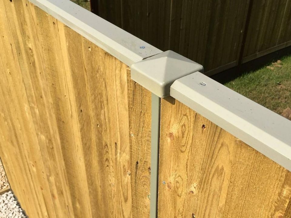 Featheredge panel between galvanised steel posts finished with a grey plastic post cap