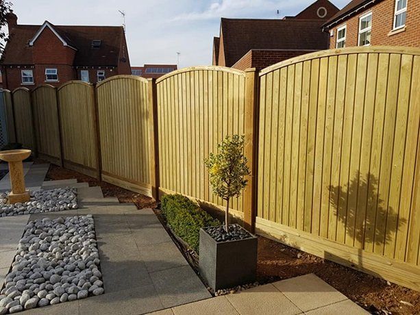 Arched-top fence panels stepping down a sloping garden