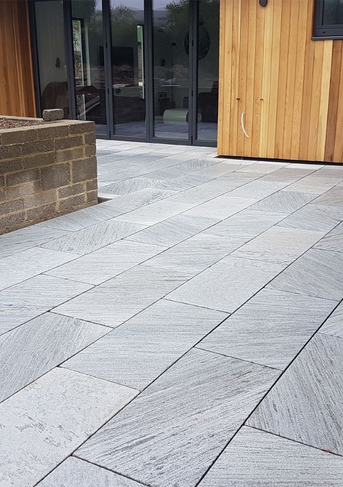 Pale grey marble-effect patio outside bi-fold doors in Cardiff