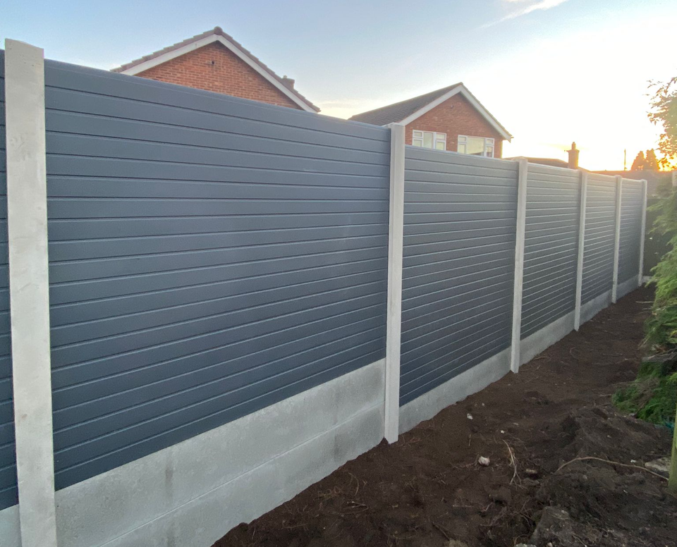 Grey eco composite fence panels in concrete posts with smooth concrete gravel boards