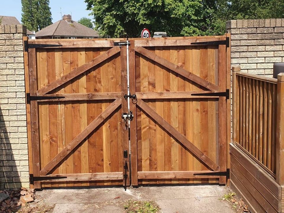 Pair of ledged and braced timber gates hung between brick piers
