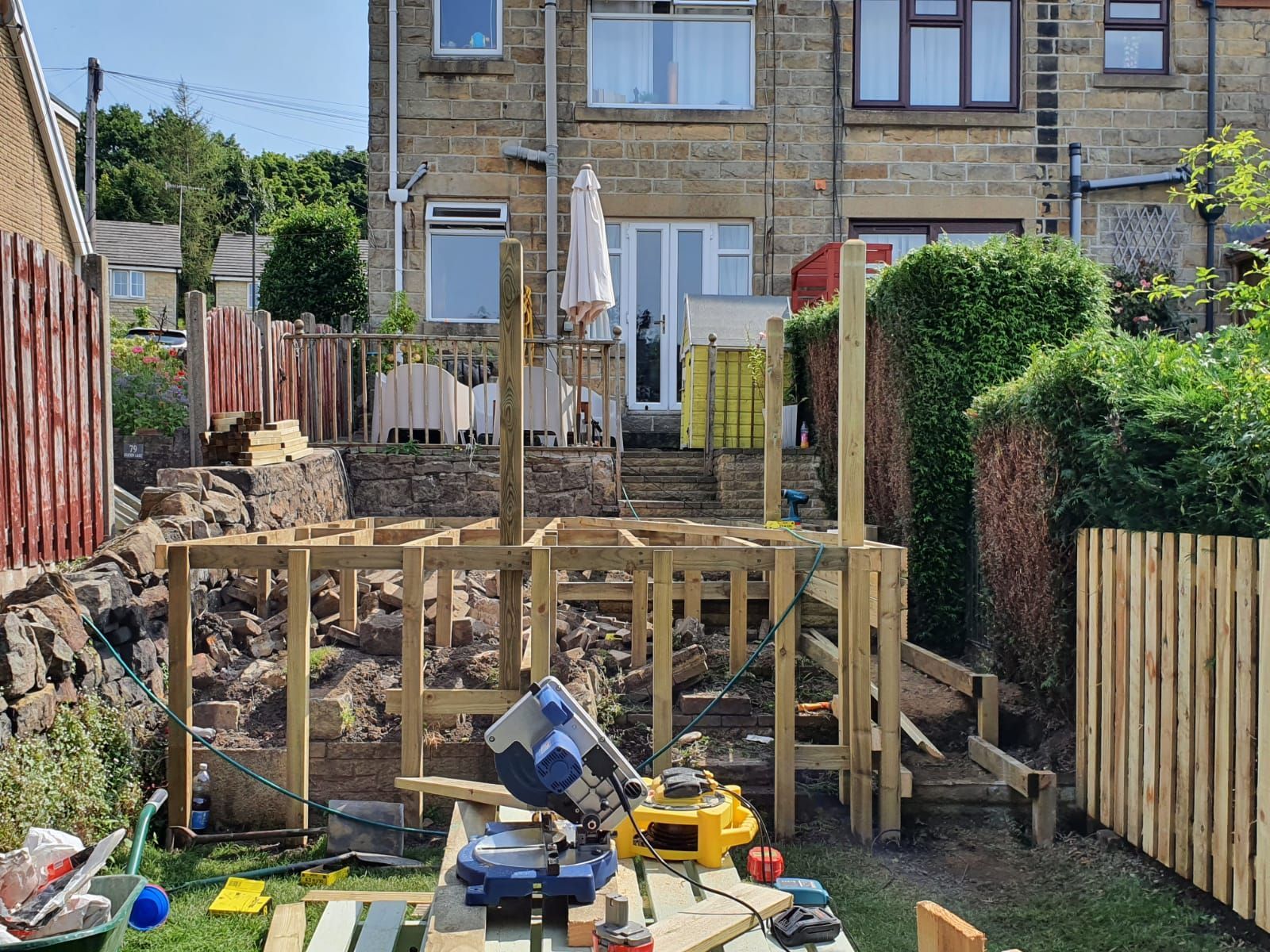 Raised wooden decking being constructed in a Gibbons Down back garden