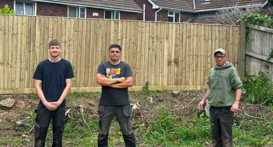 The J&Z Fencing team standing in front of a new featheredge fence