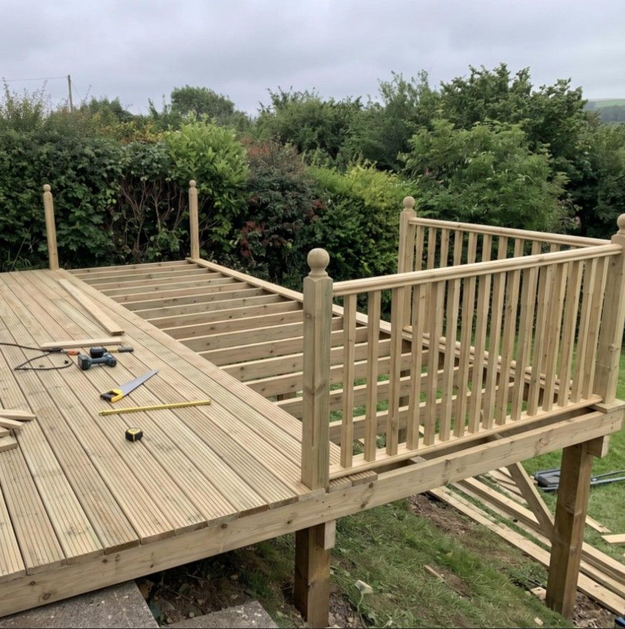 Raised deck frame and boards taking shape on a steeply sloped Cardiff garden