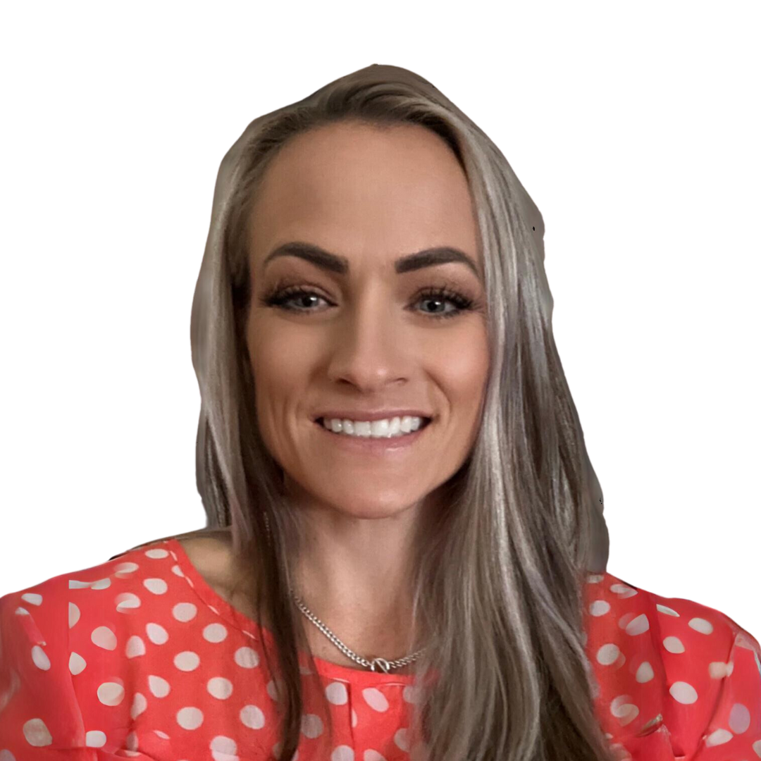 Smiling woman with long blonde hair wearing a coral polka-dot blouse against a white background