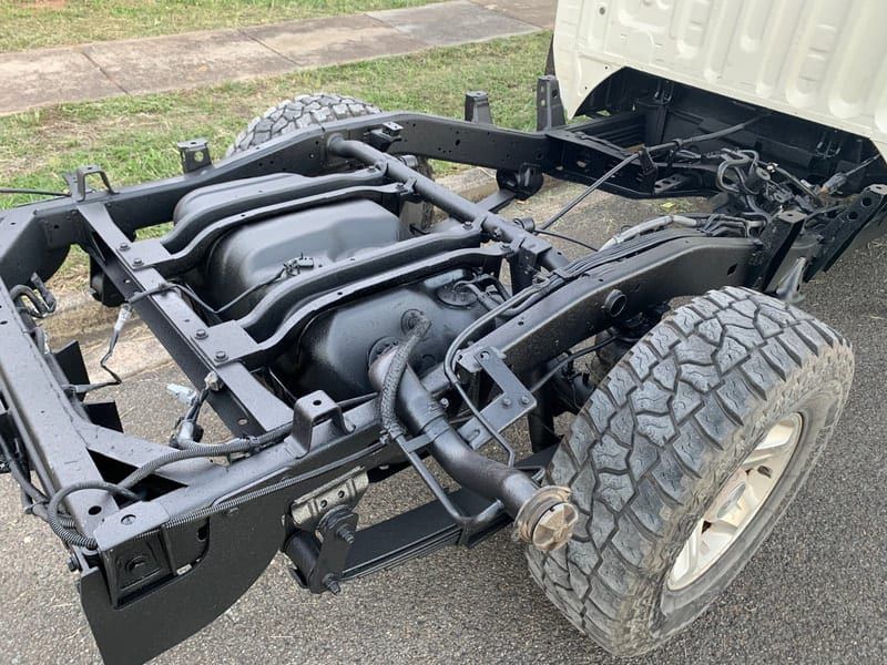 the chassis of a truck is sitting on the ground .