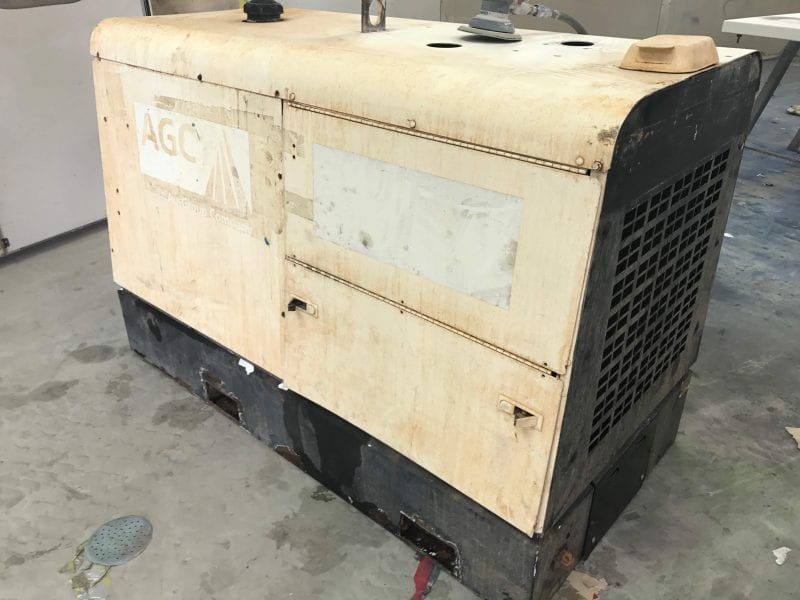 a generator is sitting on a concrete floor .
