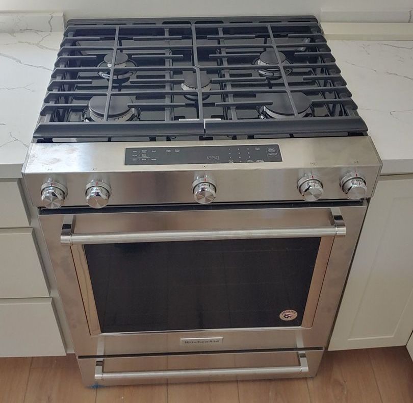 A stainless steel stove with a black door