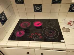A stove top oven is sitting on top of a counter in a kitchen.