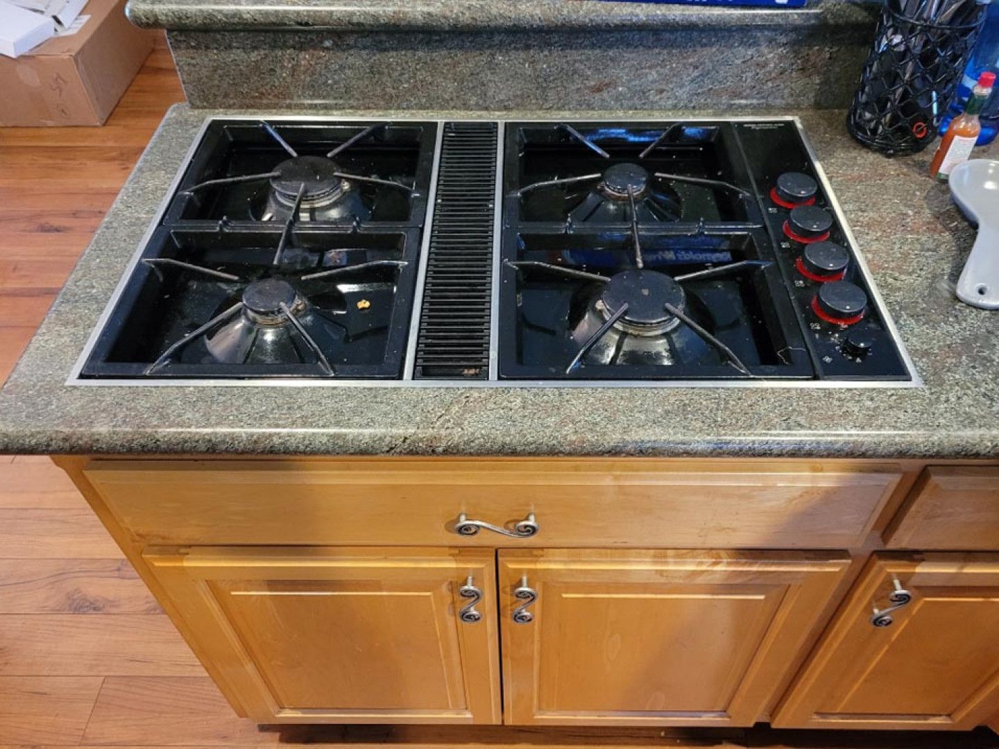 A kitchen counter with a stove top oven on it