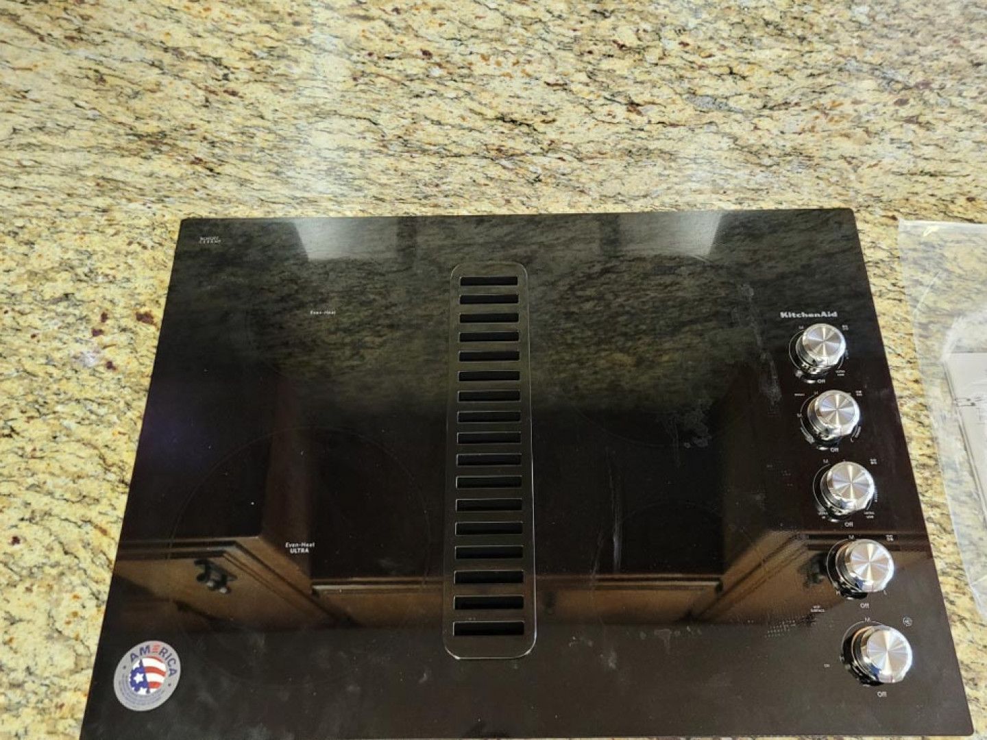 A black stove top with a united states of america logo on it
