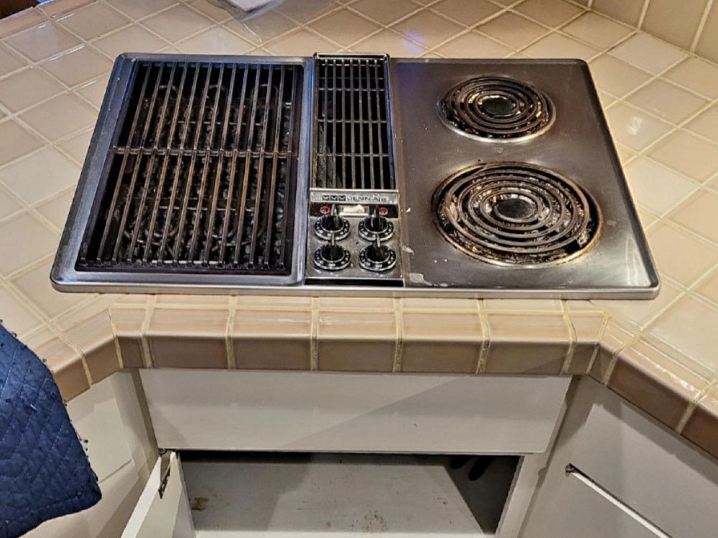 A stove with two burners and a grill on top of it