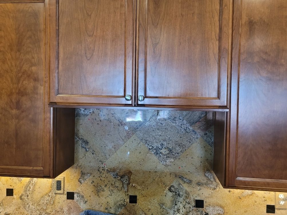 A kitchen with wooden cabinets and granite counter tops