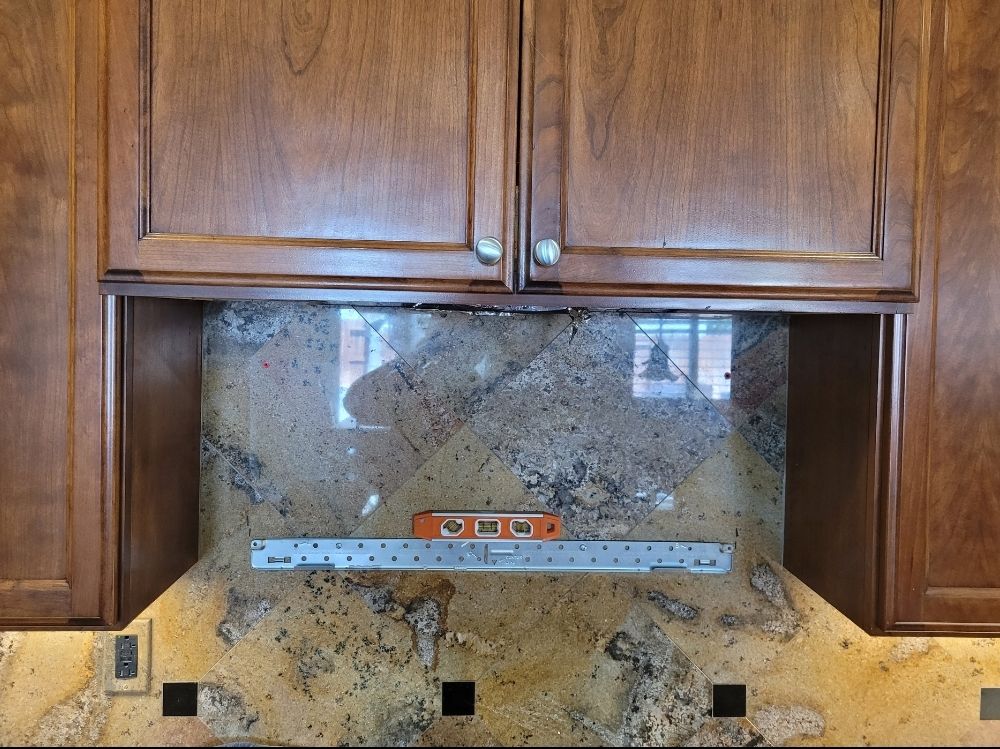 A kitchen with wooden cabinets and granite counter tops