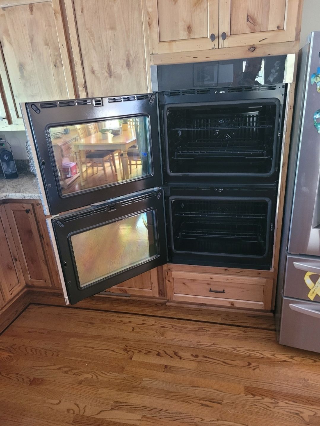 A double oven in a kitchen with the door open.