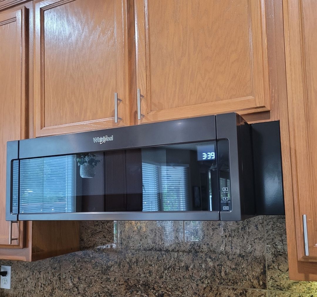 A whirlpool over the range microwave in a kitchen