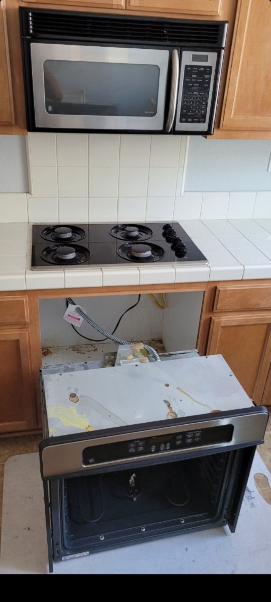 A kitchen with a stove top oven and a microwave.
