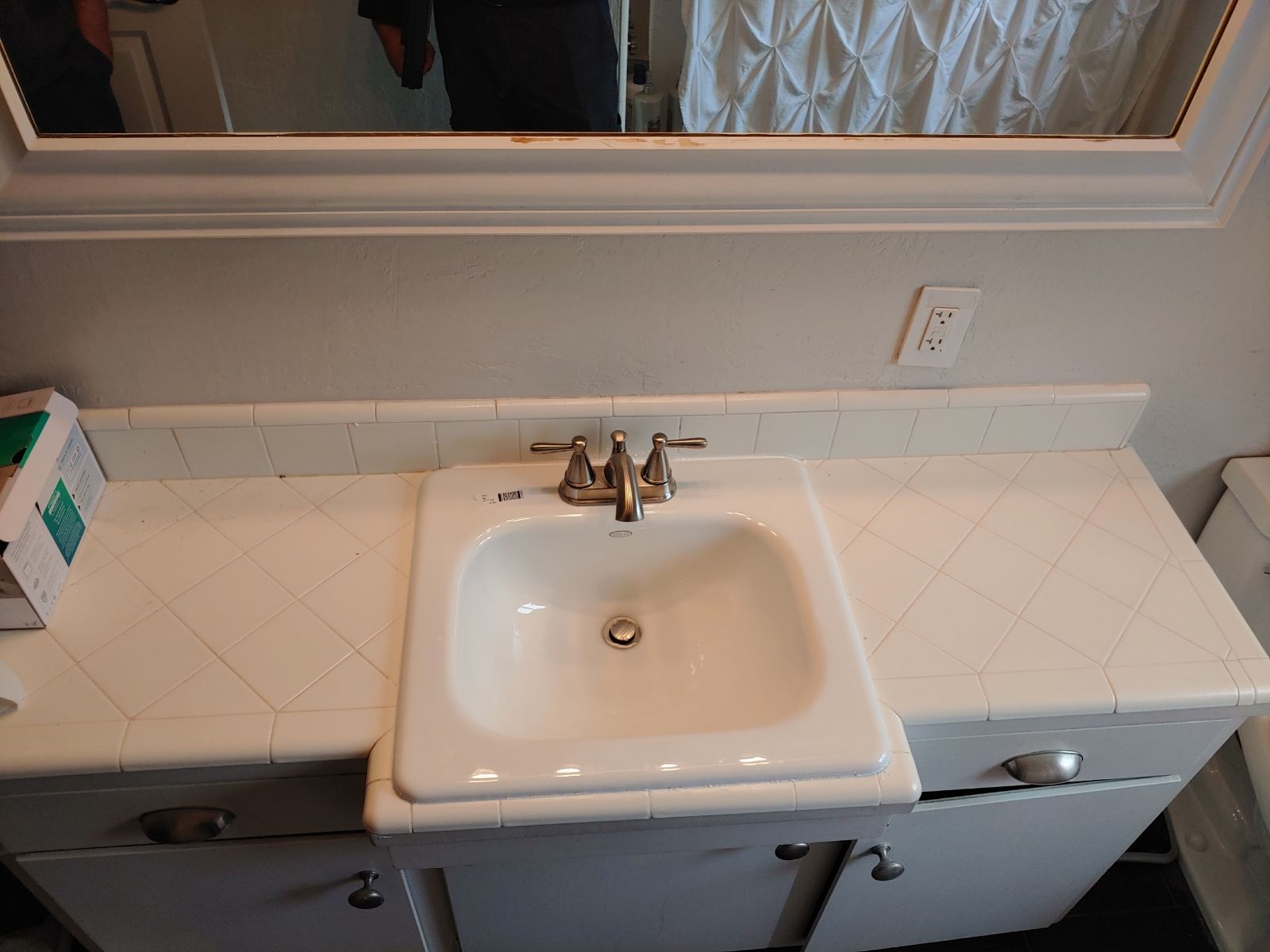 A bathroom vanity with a sink and a mirror
