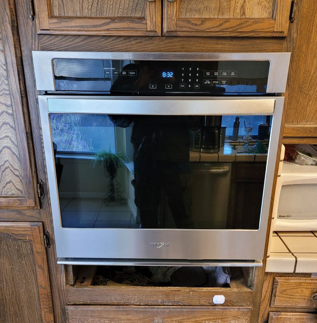 A stainless steel oven is sitting in a kitchen.