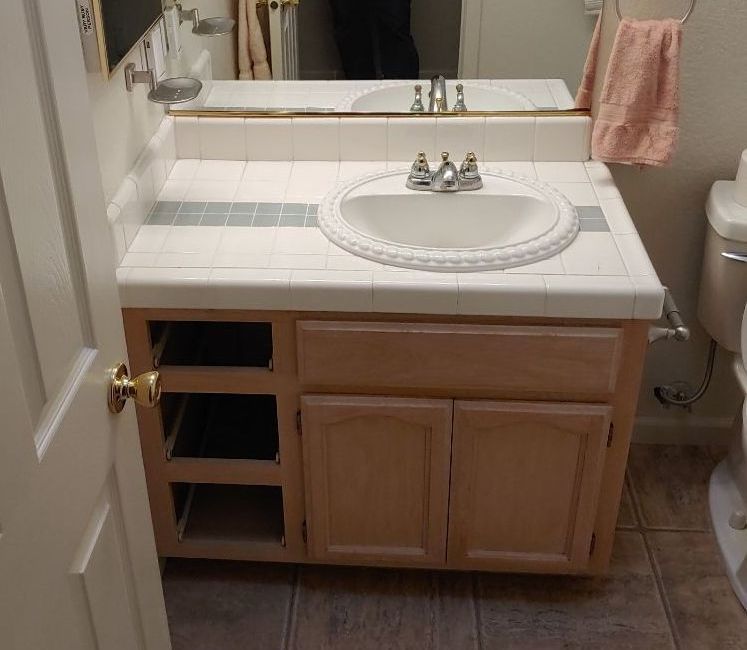A bathroom with a sink a toilet and a mirror