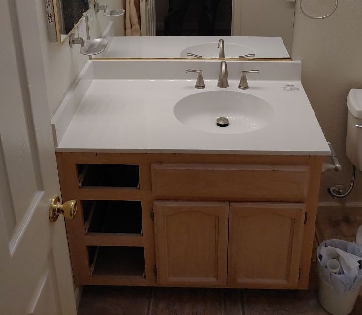 A bathroom vanity with a sink and a mirror
