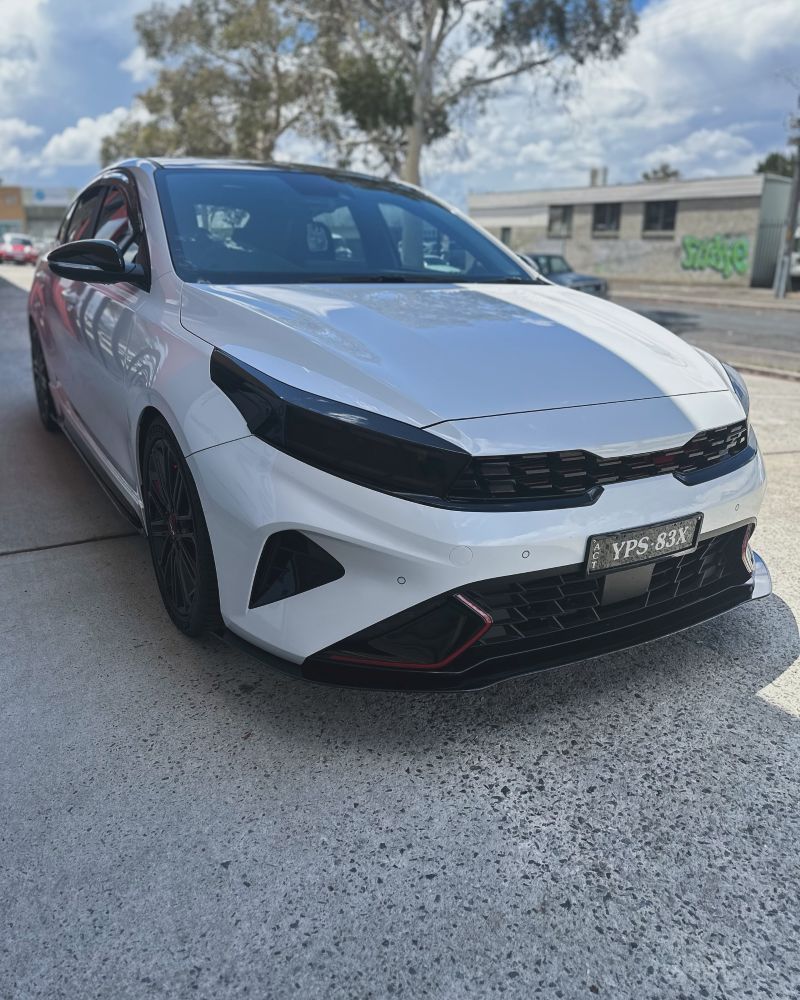 A White Car is Parked on the Side of the Road — Platinum Hand Car Wash & Detailing in Belconnen, ACT