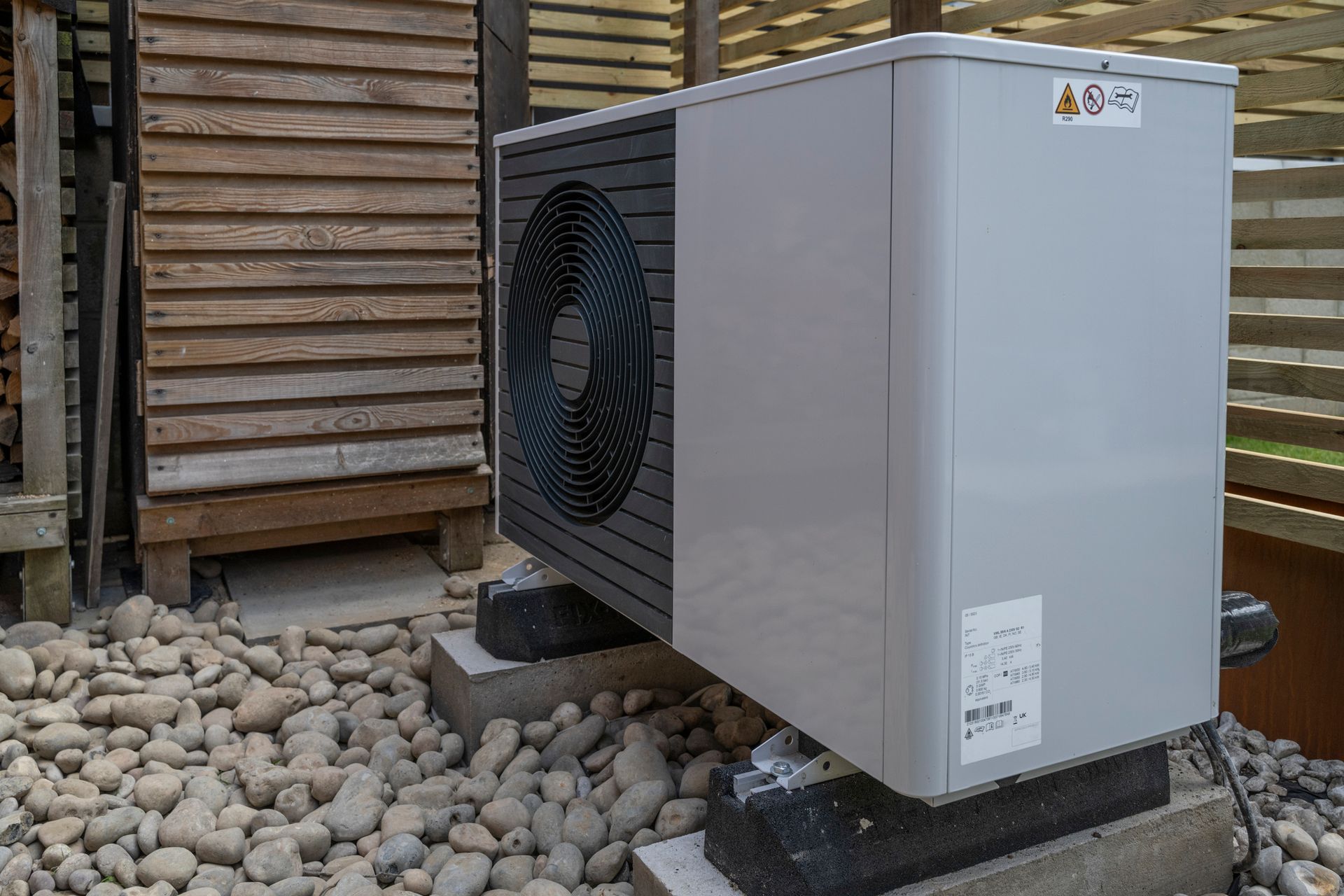 Outdoor heat pump unit installed beside a home in Powell, Wyoming.